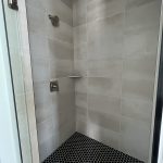 bathroom shower with black hexagon tile